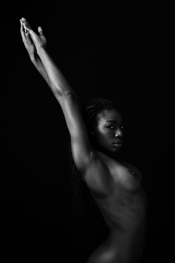 Nude Black woman with eyes opened, soft light and poise