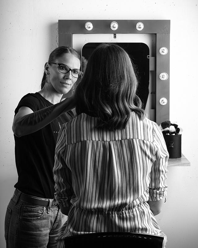 Cristina Ortega, professional makeup artist preparing client in Zurich